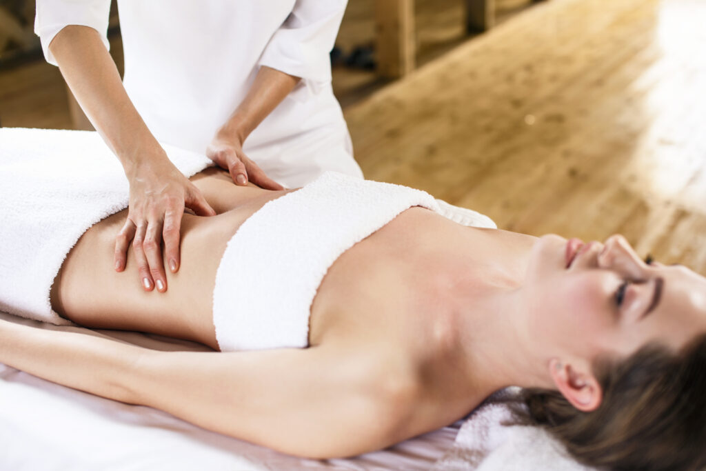 Woman receiving abdominal massage