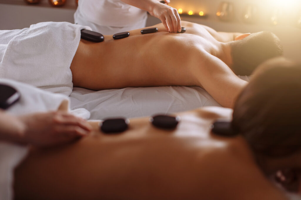 A couple receives hot stone massage