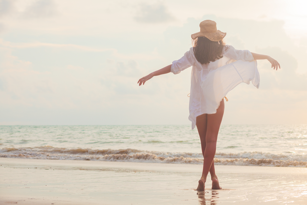 woman on beach with beautiful and energized legs after a vital energy gel treatment